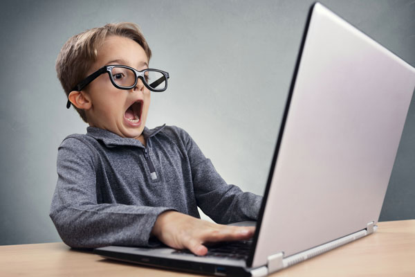 Boy screaming at computer
