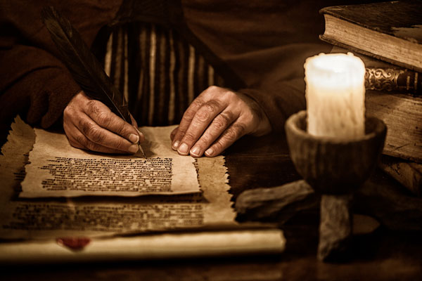 Man writing with feather pen