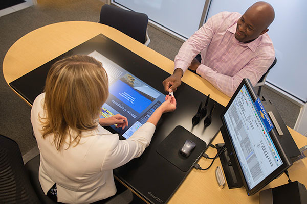 Salesperson handing customer USB