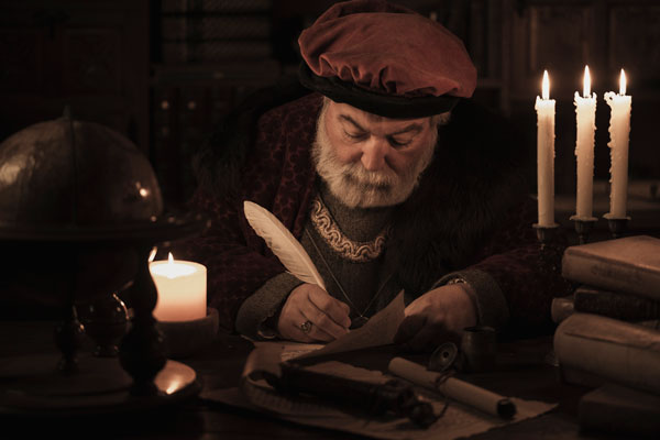 Man signing paper with feather