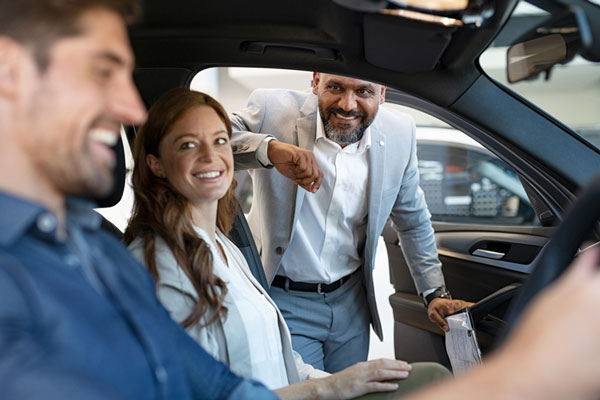 Couple sitting in front seat of car