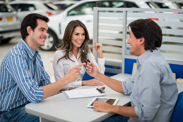 Couple sitting down with salesperson