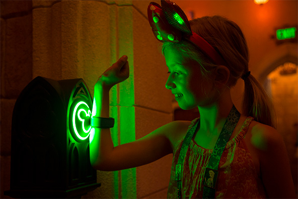 Young girl scanning Disney wristband