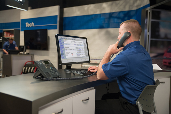 Service advisor at desk answering phone