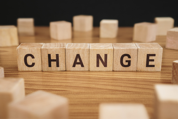 Letter blocks on table, spelling "change"