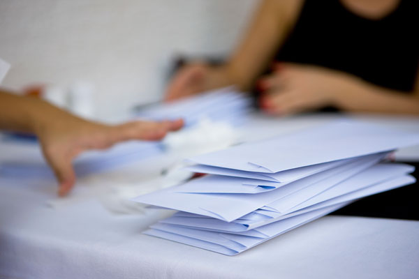 Pile of mailing envelopes on desk