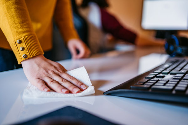 Woman cleaning desk