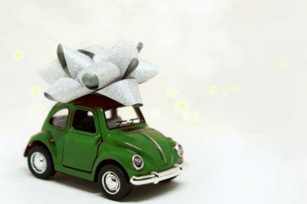 Green toy car with a bow on top