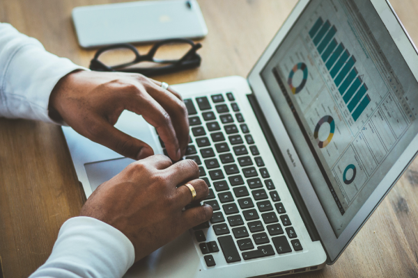 person looking at analytics on a laptop