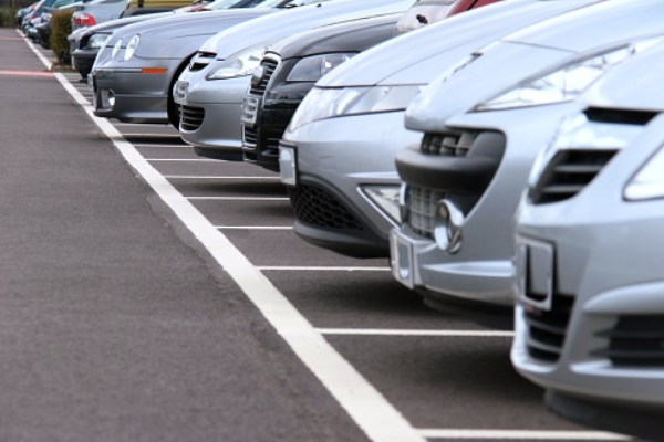 line of car bumpers in a dealership parking lot