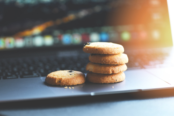 Cookies sitting on top of a laptop keyboard.
