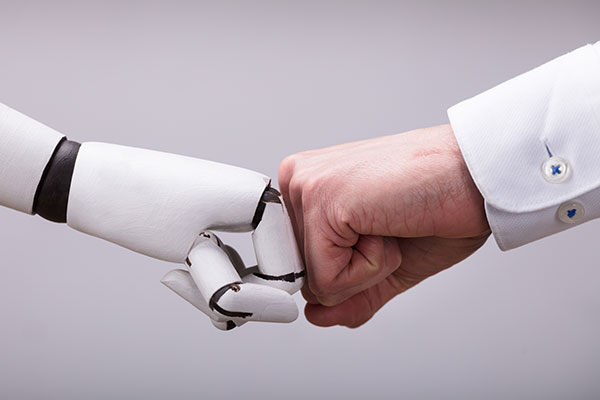 Robot hand fist bumping a human hand in a collaborative way