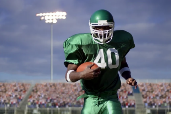 football player standing on a field in a stadium